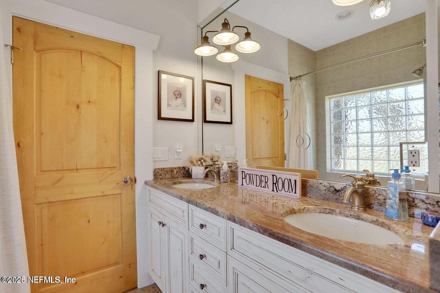 1403 Ocean Front Neptune Beach, FL 32266 - Photo 15 of 37 a bathroom with double vanity sinks a vanity and a mirror