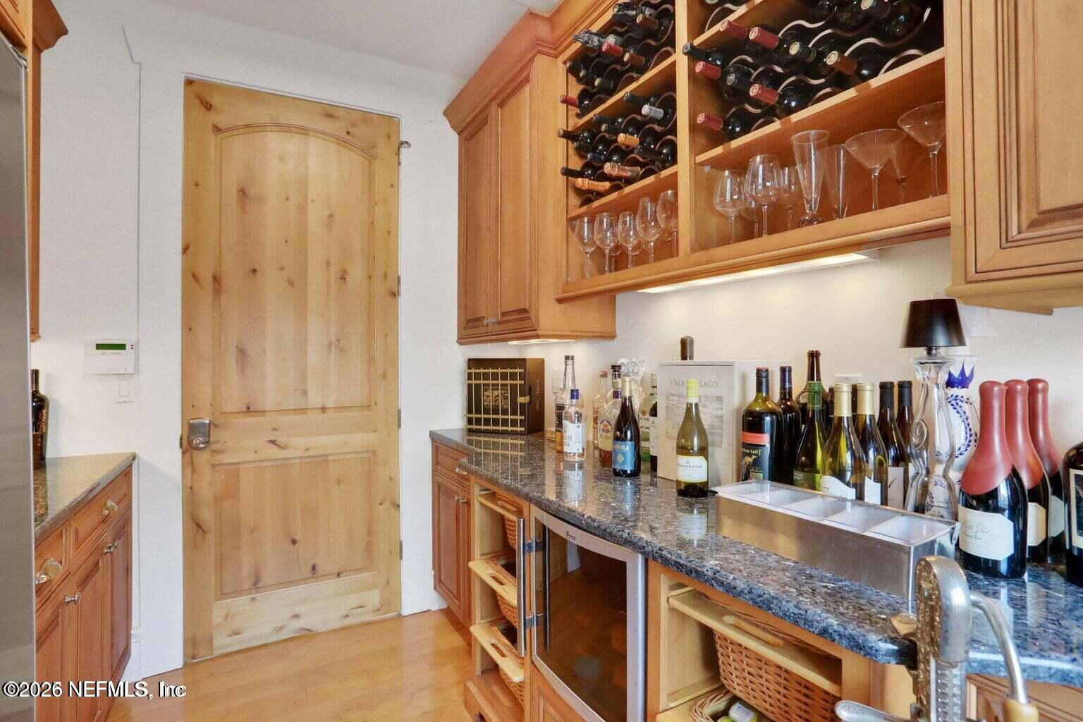 1403 Ocean Front Neptune Beach, FL 32266 - Photo 17 of 37 a kitchen with stainless steel appliances granite countertop a refrigerator and a sink