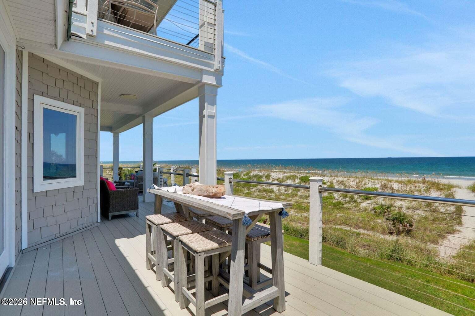 1403 Ocean Front Neptune Beach, FL 32266 - Photo 20 of 37 a view of a balcony with table and chairs