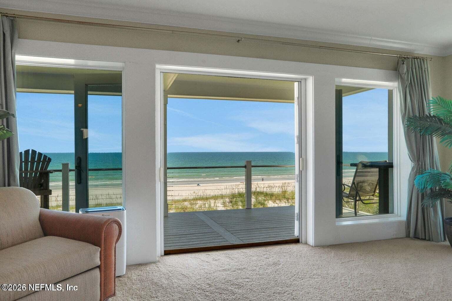 1403 Ocean Front Neptune Beach, FL 32266 - Photo 24 of 37 a living room with furniture and a floor to ceiling window