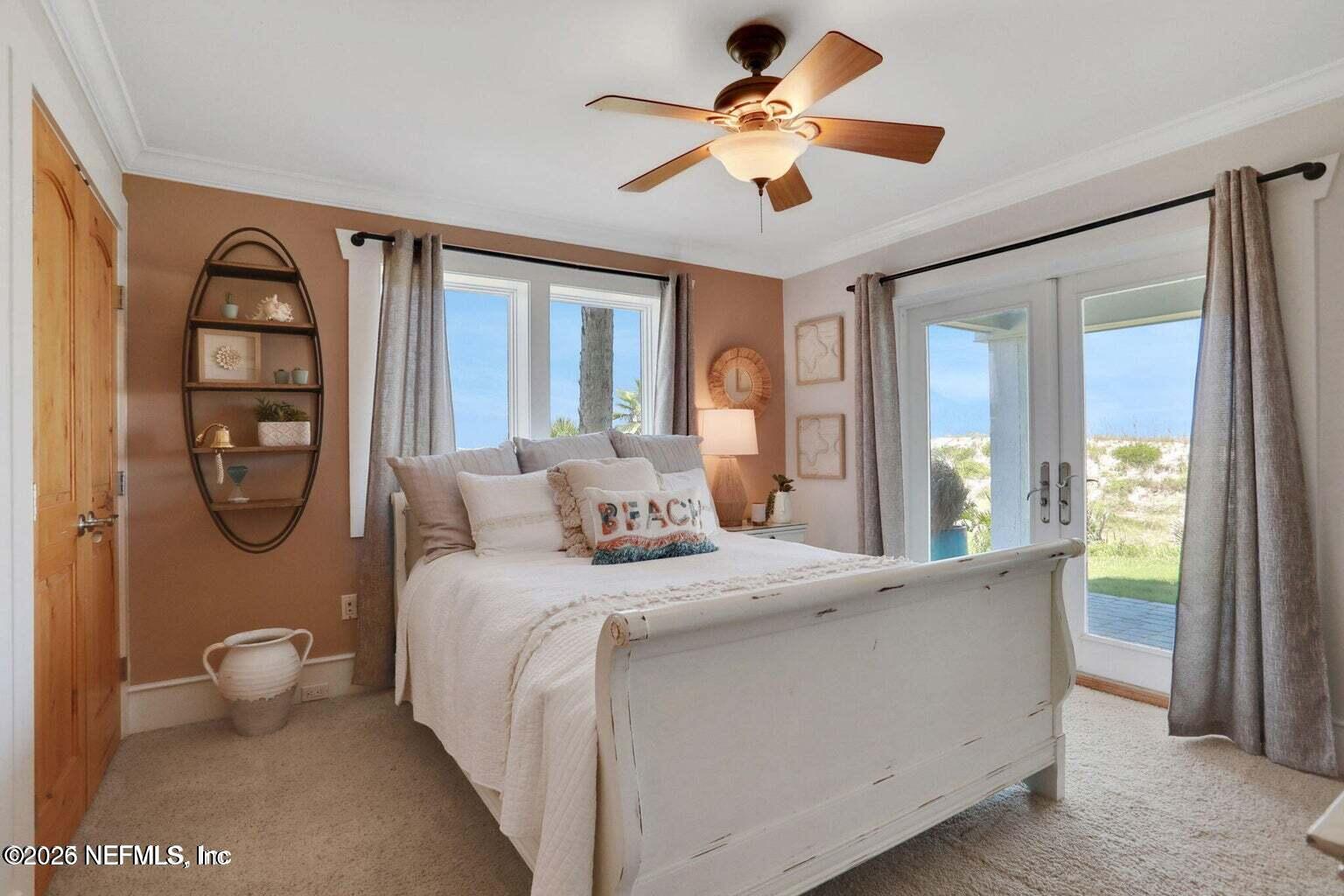 1403 Ocean Front Neptune Beach, FL 32266 - Photo 29 of 37 a bedroom with a large bed and a chandelier