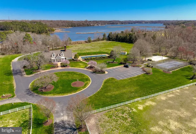 an aerial view of a house with outdoor space and lake view