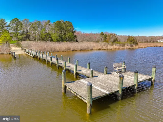 a view of a lake with couches chairs