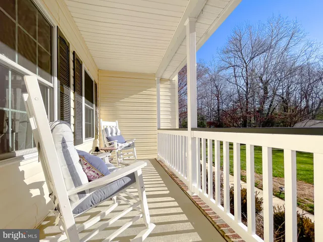 a view of balcony with wooden floor and outdoor seating