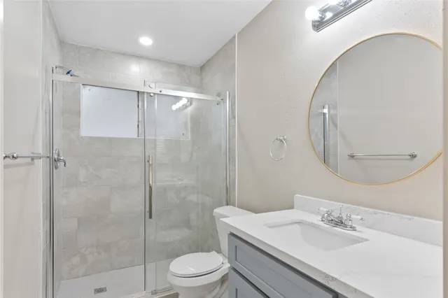 a bathroom with a sink toilet and shower