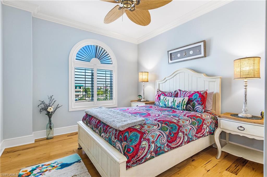 900 5th Avenue South, Unit 301 Naples, FL 34102 - Photo 12 of 18 a bedroom with a bed and a chandelier