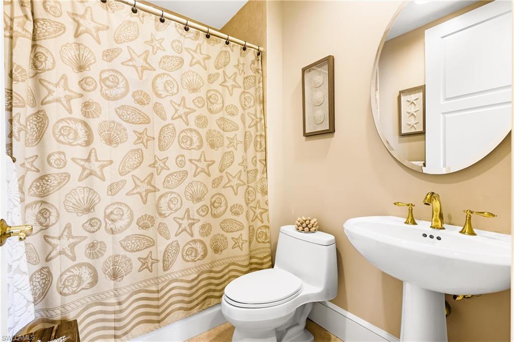 900 5th Avenue South, Unit 301 Naples, FL 34102 - Photo 13 of 18 a bathroom with a sink and a mirror