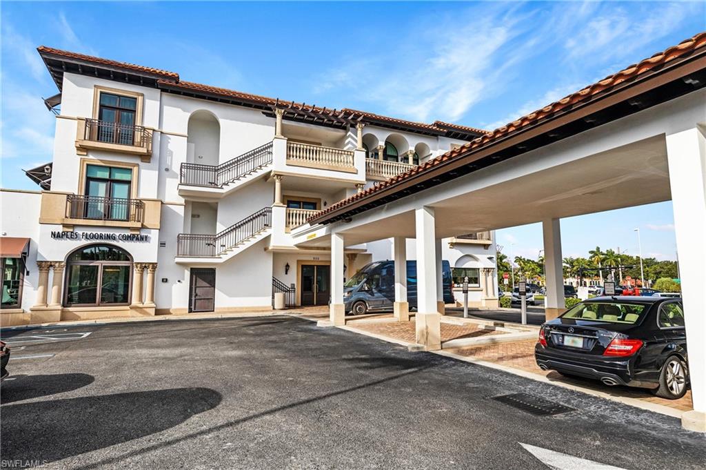 900 5th Avenue South, Unit 301 Naples, FL 34102 - Photo 16 of 18 a cars parked in front of a building