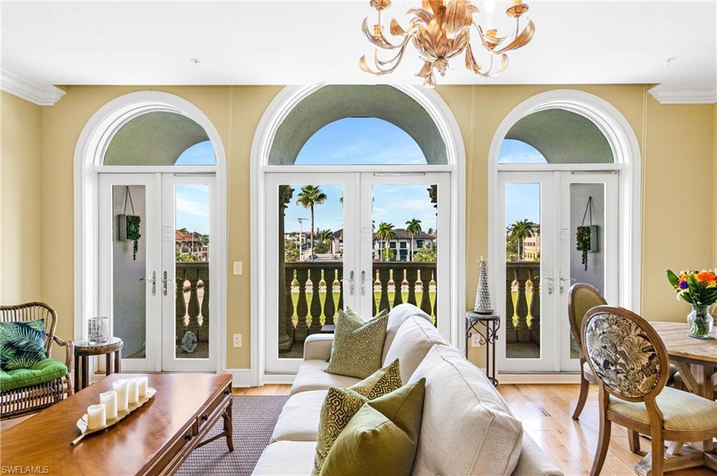 900 5th Avenue South, Unit 301 Naples, FL 34102 - Photo 4 of 18 a living room with furniture fireplace and wooden floor
