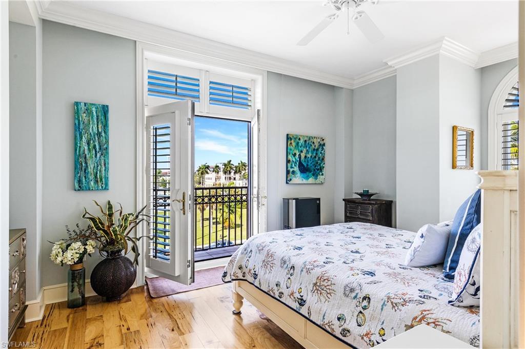 900 5th Avenue South, Unit 301 Naples, FL 34102 - Photo 8 of 18 a bedroom with a bed and a large window
