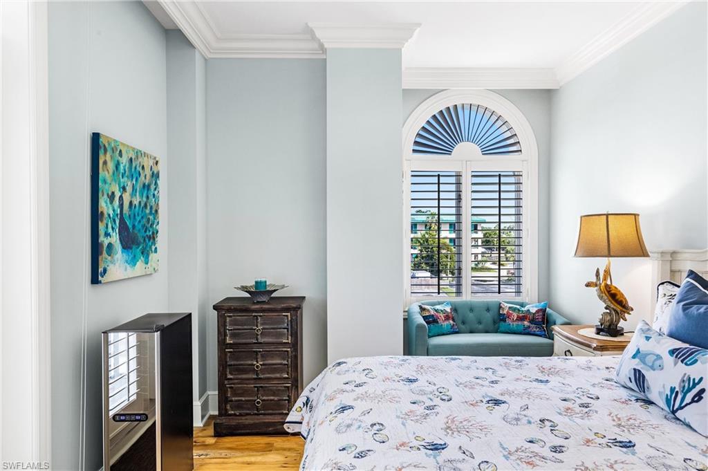 900 5th Avenue South, Unit 301 Naples, FL 34102 - Photo 9 of 18 a bedroom with a bed and a window