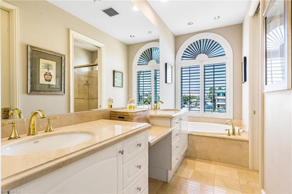 900 5th Avenue South, Unit 301 Naples, FL 34102 - Photo 10 of 18 a spacious bathroom with a sink a bathtub and a shower