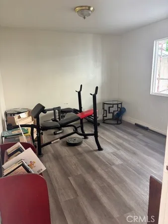 a living room with furniture and gym equipment