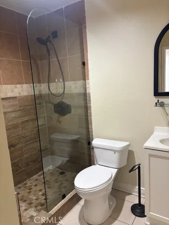 a bathroom with a toilet and a shower