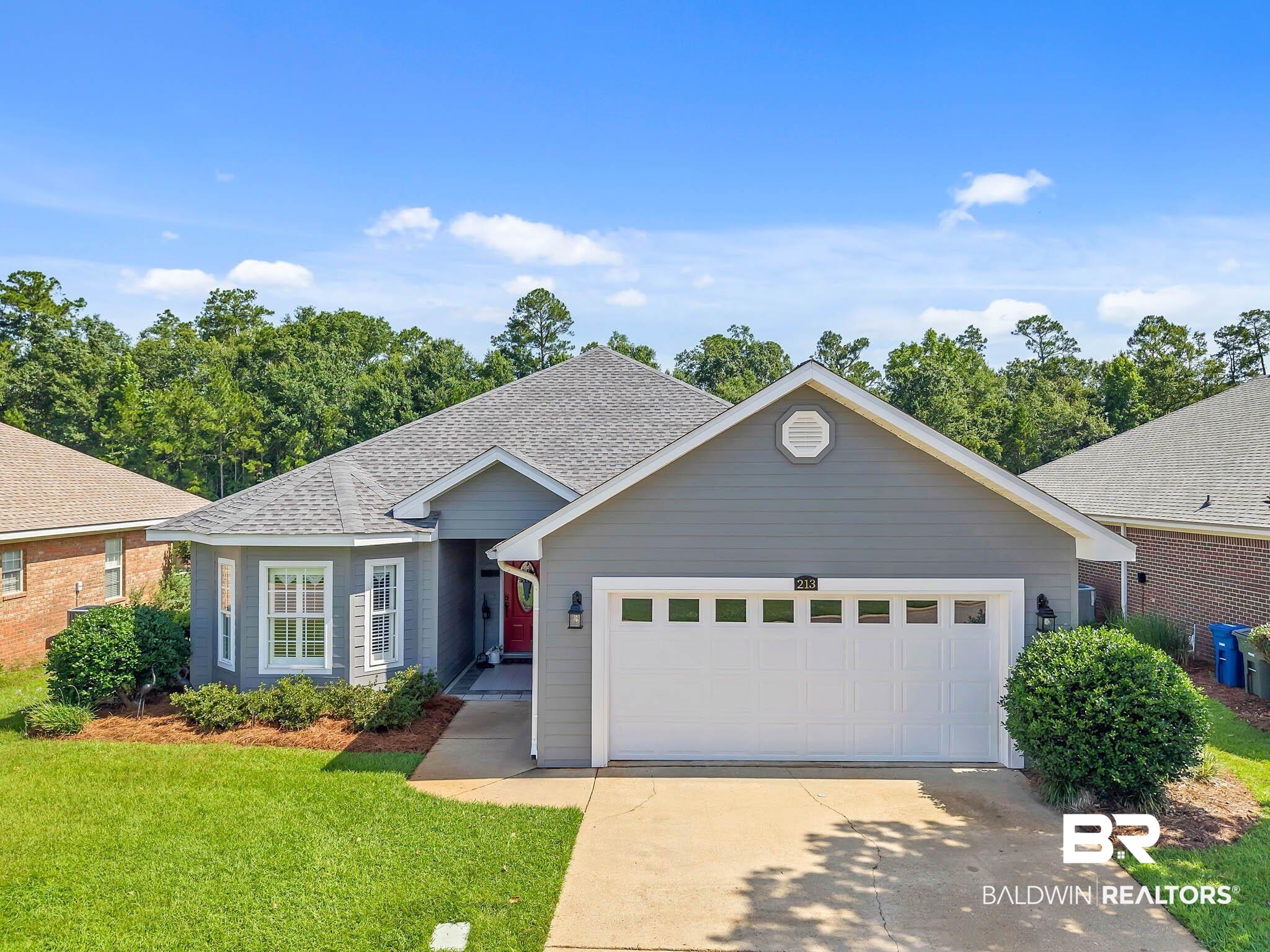 213 Hemingway Loop Foley, AL 36535 - Photo 3 of 69 Single story home with concrete driveway, a front yard, a garage, and a shingled roof