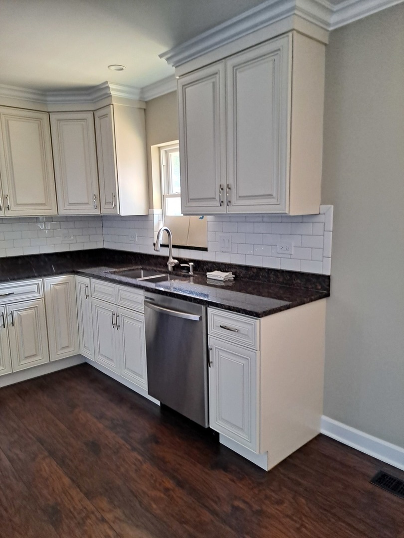 601 West Romeo Road Romeoville, IL 60446 - Photo 3 of 29 a kitchen with granite countertop white cabinets and a hard wood floors
