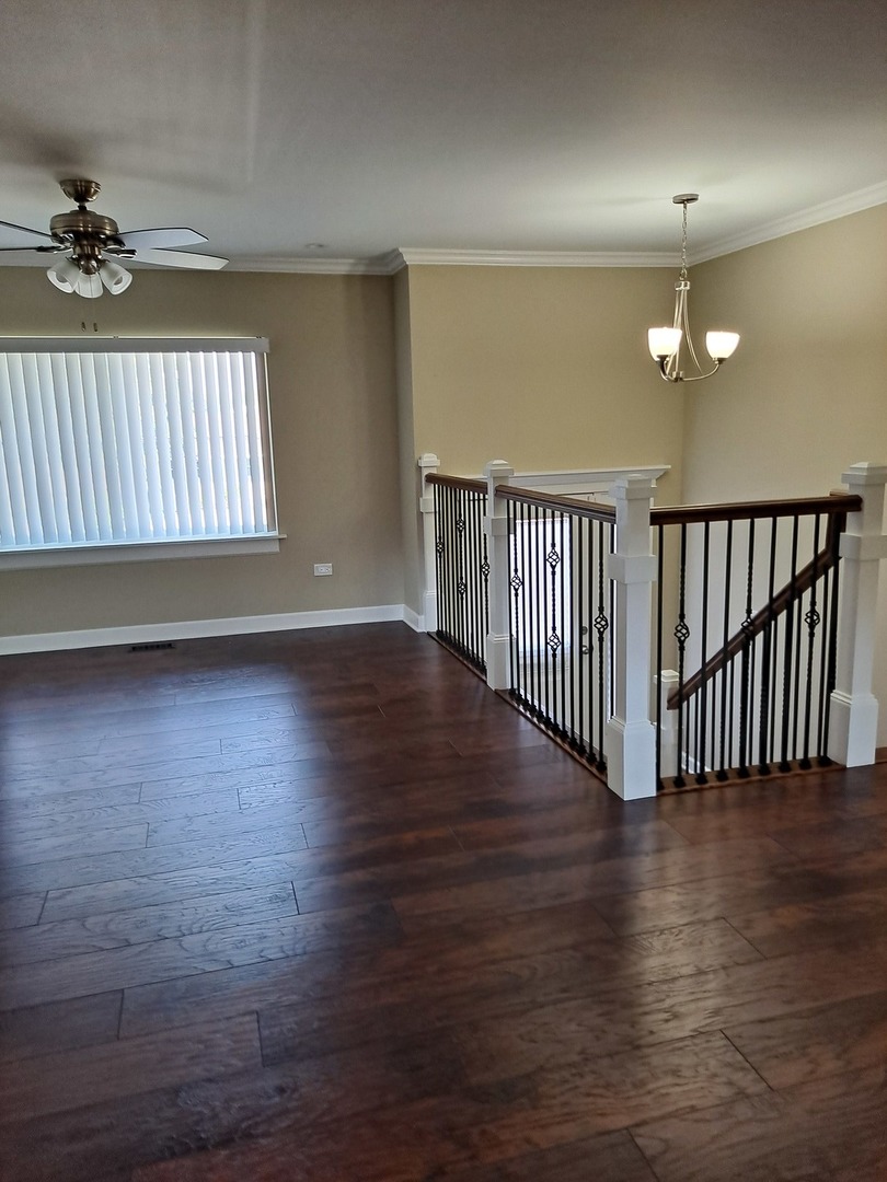 601 West Romeo Road Romeoville, IL 60446 - Photo 8 of 29 wooden floor in an empty room with a window