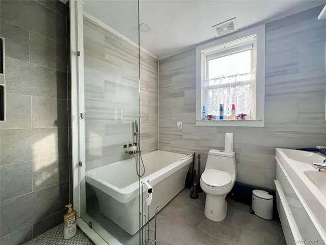 a white bath tub sitting next to a white toilet