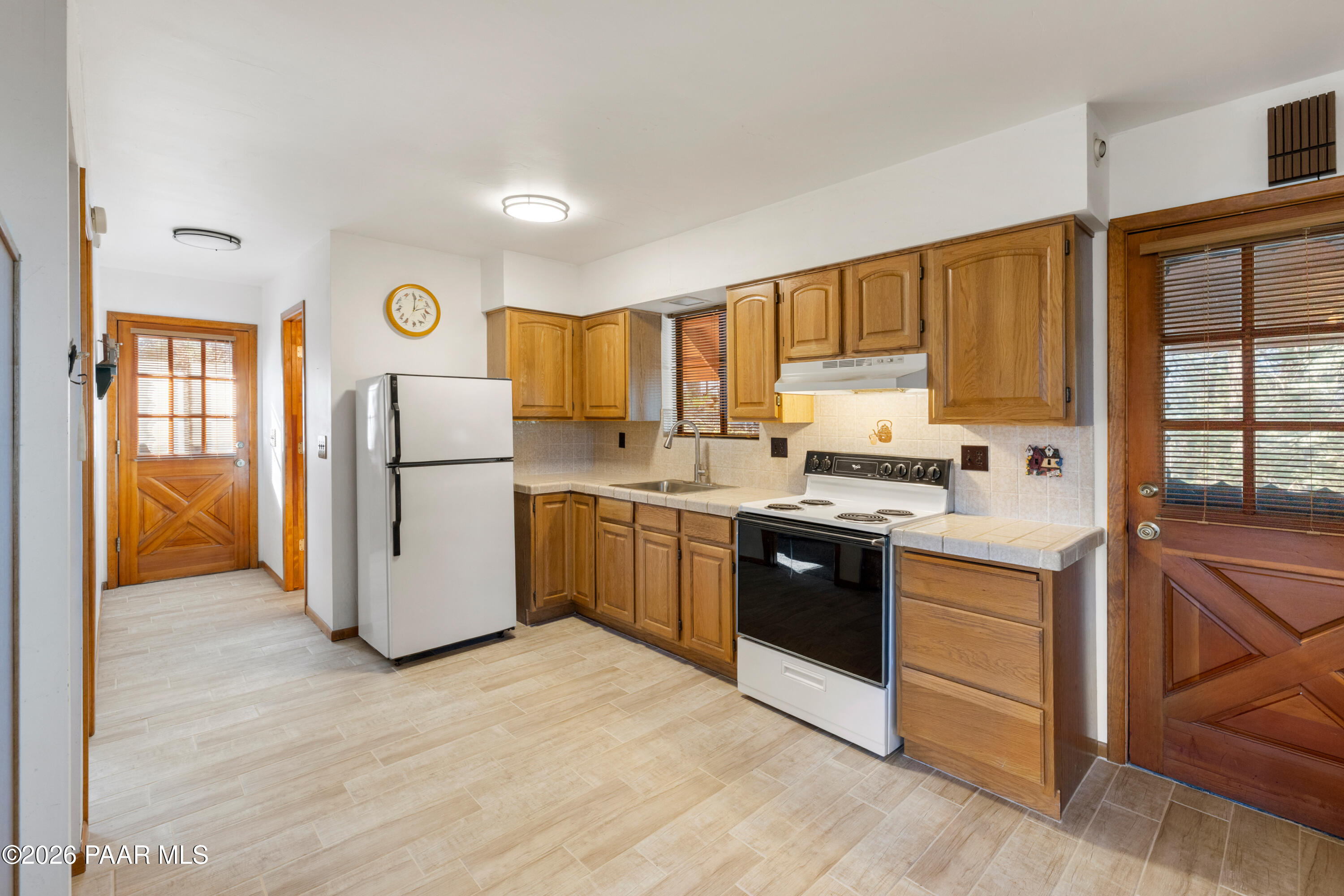 8520 South Hoot Owl Ridge Drive Prescott, AZ 86303 - Photo 5 of 25 a kitchen with a refrigerator sink and cabinets