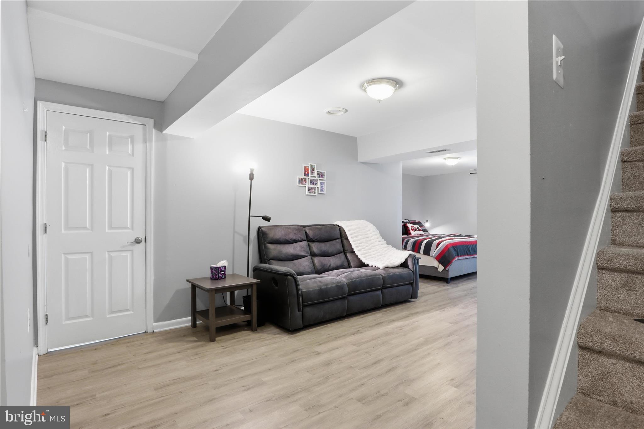 71 Kinsman View Circle Silver Spring, MD 20901 - Photo 11 of 42 a living room with furniture and a wooden floor