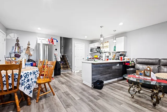 a living room filled with furniture and a wooden floor