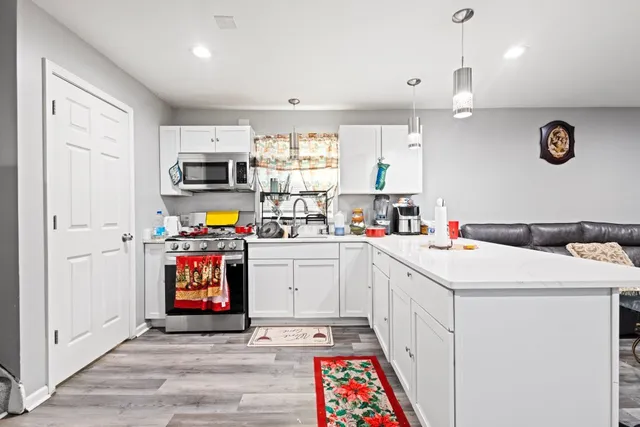 a utility room with cabinets washer and dryer
