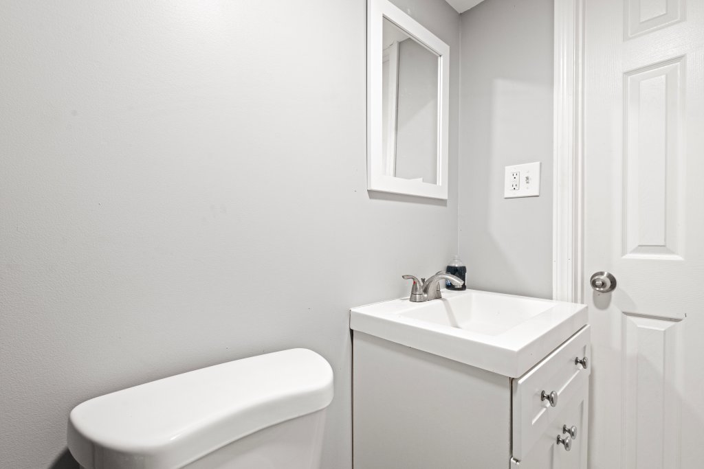 14564 Spaulding Avenue Harvey, IL 60426 - Photo 10 of 20 a bathroom with a toilet a sink and mirror