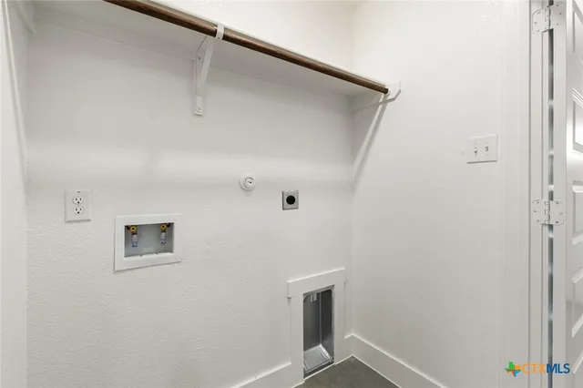 a view of a house with a small yard and wooden fence