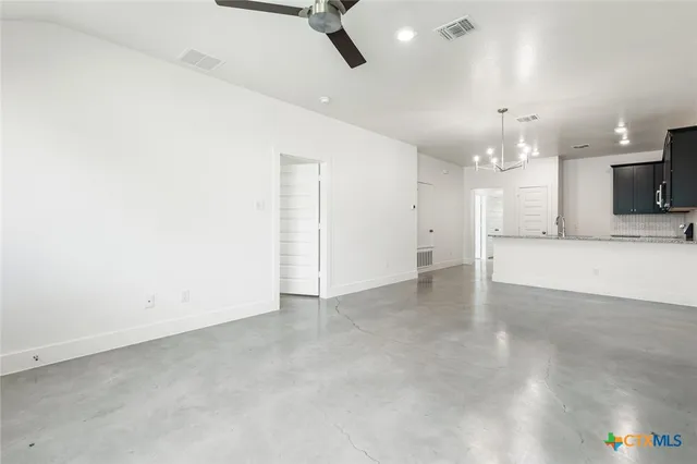 a view of a kitchen with a sink and a refrigerator