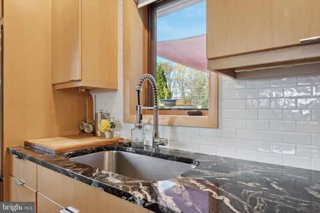 a kitchen with a sink and a window