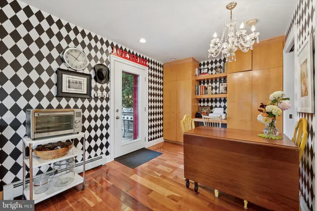 a view of a dining room with furniture and chandelier