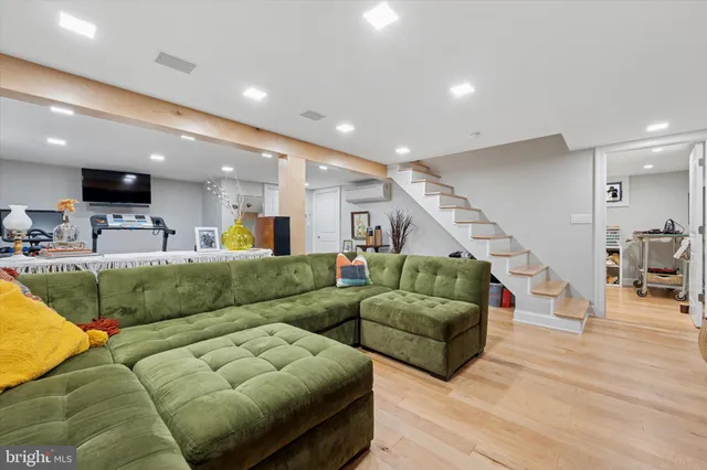 a living room with furniture and kitchen view