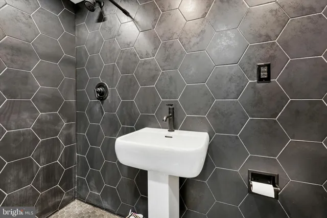a bathroom with a sink toilet and a mirror