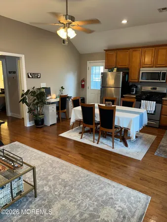 a living room with furniture a piano and a flat screen tv
