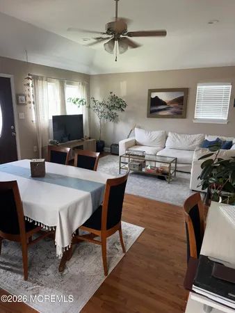 a living room with furniture a chandelier and a flat screen tv