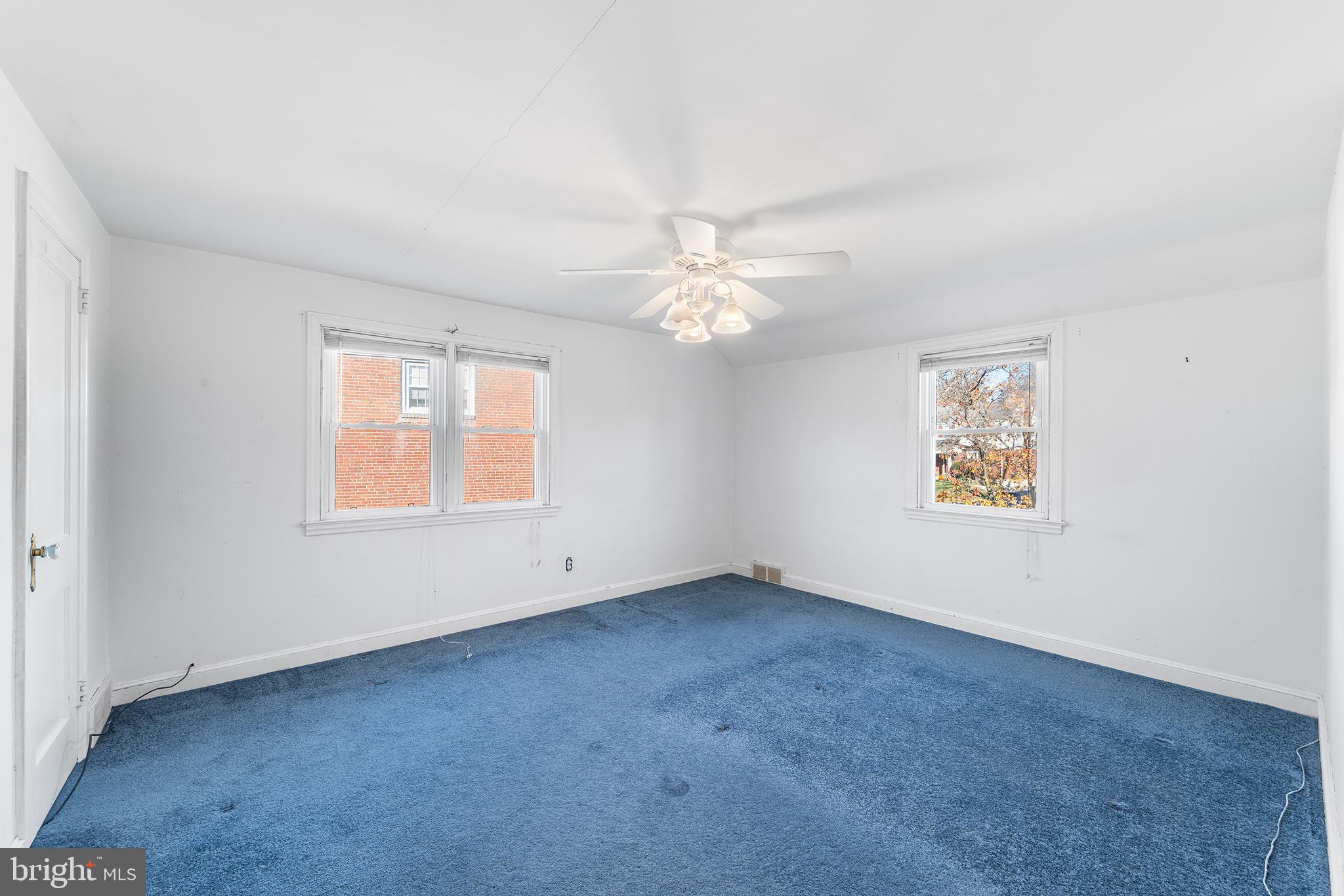 104 Brentwood Road Havertown, PA 19083 - Photo 21 of 28 an empty room with windows and chandelier fan