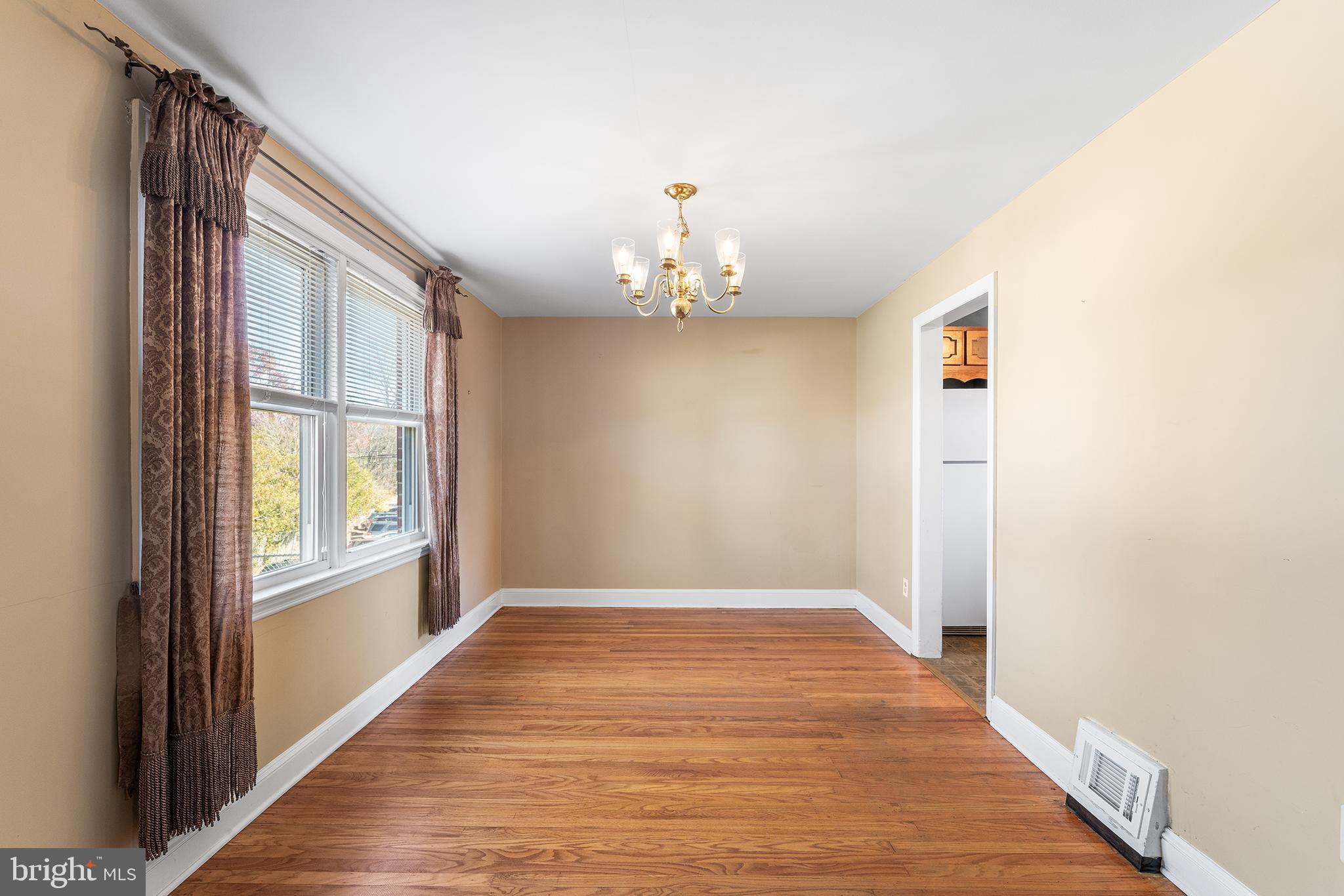 104 Brentwood Road Havertown, PA 19083 - Photo 9 of 28 a view of an empty room with wooden floor and a window
