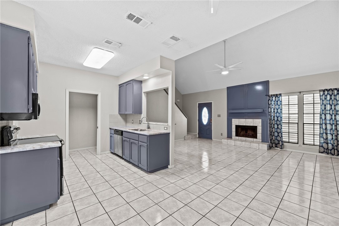 3025 Quail Springs Road, Unit B7 Corpus Christi, TX 78414 - Photo 3 of 23 a large kitchen with a stove top oven a sink a counter space and cabinets