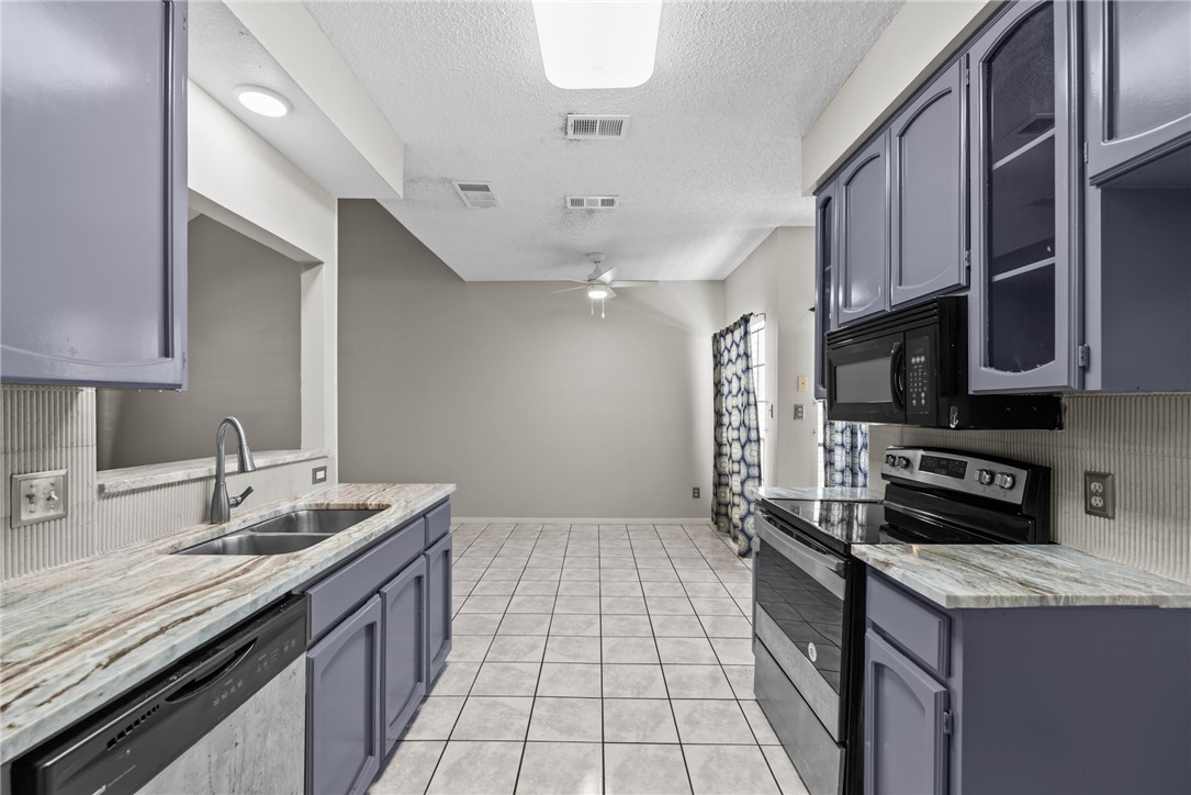3025 Quail Springs Road, Unit B7 Corpus Christi, TX 78414 - Photo 5 of 23 a kitchen with stainless steel appliances granite countertop a sink stove and cabinets