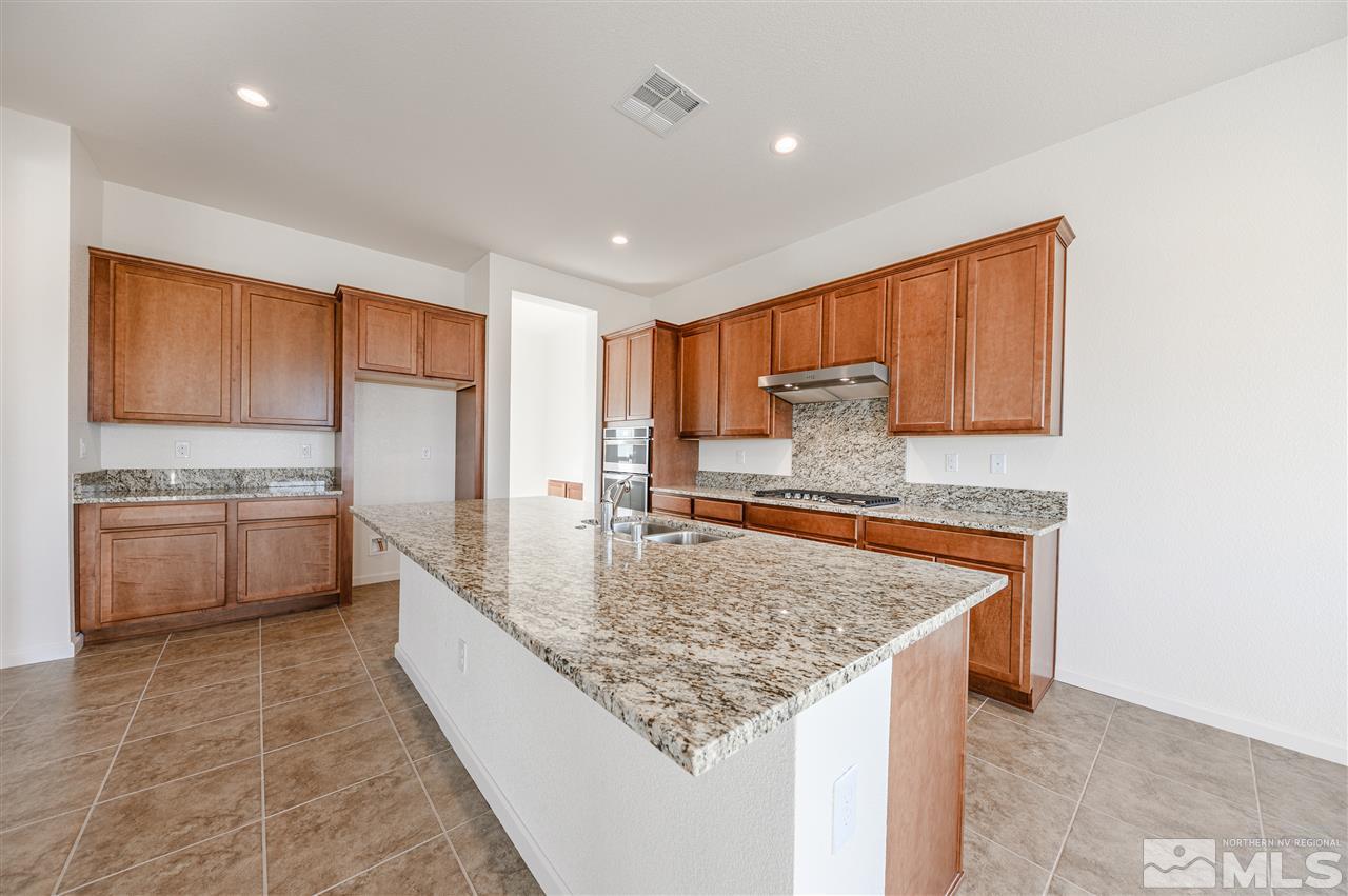 9257 Blue Basin Trail, Unit HOMESITE 16 Reno, NV 89521 - Photo 11 of 22 a kitchen with stainless steel appliances granite countertop a sink stove and cabinets