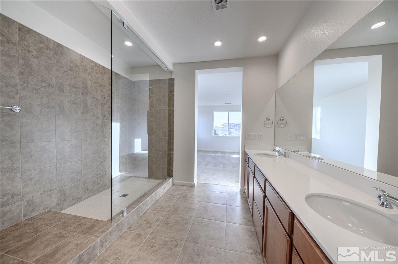 9257 Blue Basin Trail, Unit HOMESITE 16 Reno, NV 89521 - Photo 15 of 22 a bathroom with a sink and a mirror