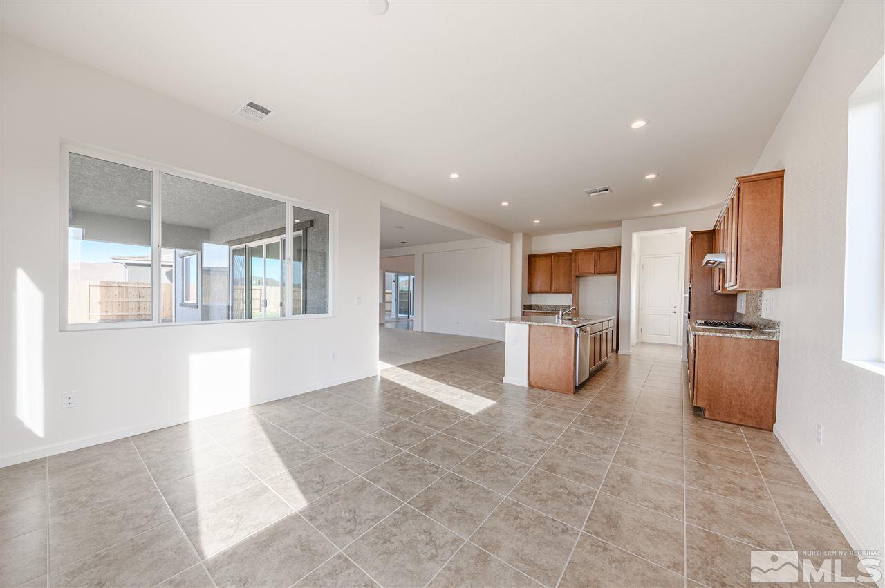 9257 Blue Basin Trail, Unit HOMESITE 16 Reno, NV 89521 - Photo 7 of 22 a view of a kitchen with refrigerator and a sink