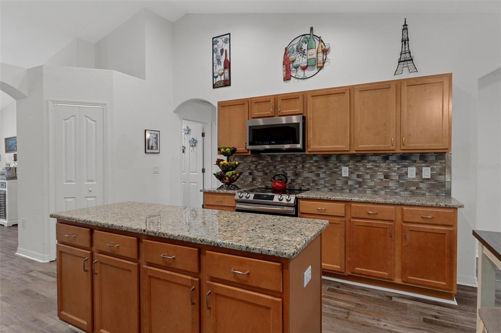 7 Bigleaf Court Homosassa, FL 34446 - Photo 24 of 71 a kitchen with granite countertop a sink and a stove top oven