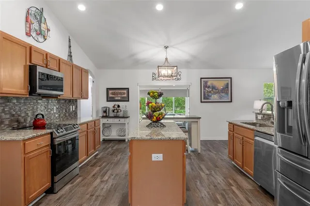 a bathroom with a granite countertop double vanity sink and a bathtub