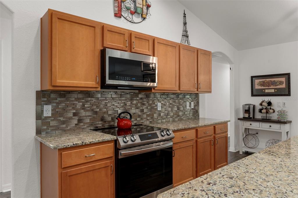 7 Bigleaf Court Homosassa, FL 34446 - Photo 26 of 71 a kitchen with stainless steel appliances granite countertop a sink stove and microwave