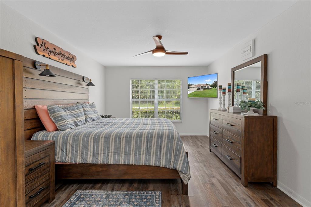 7 Bigleaf Court Homosassa, FL 34446 - Photo 30 of 71 a bedroom with a bed and a chandelier