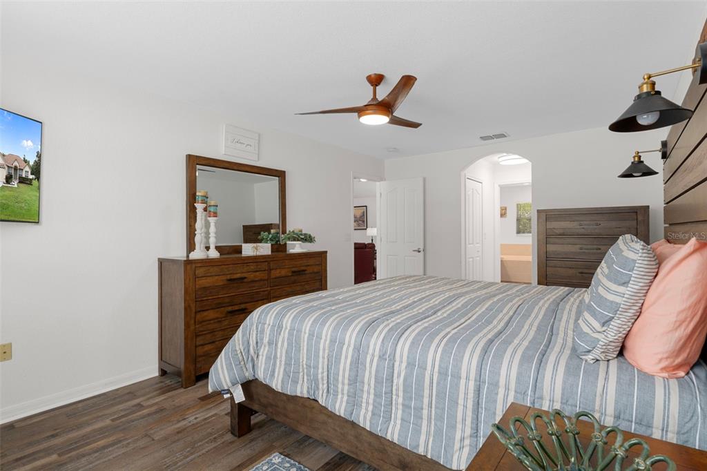 7 Bigleaf Court Homosassa, FL 34446 - Photo 31 of 71 a bedroom with a bed and wooden floor