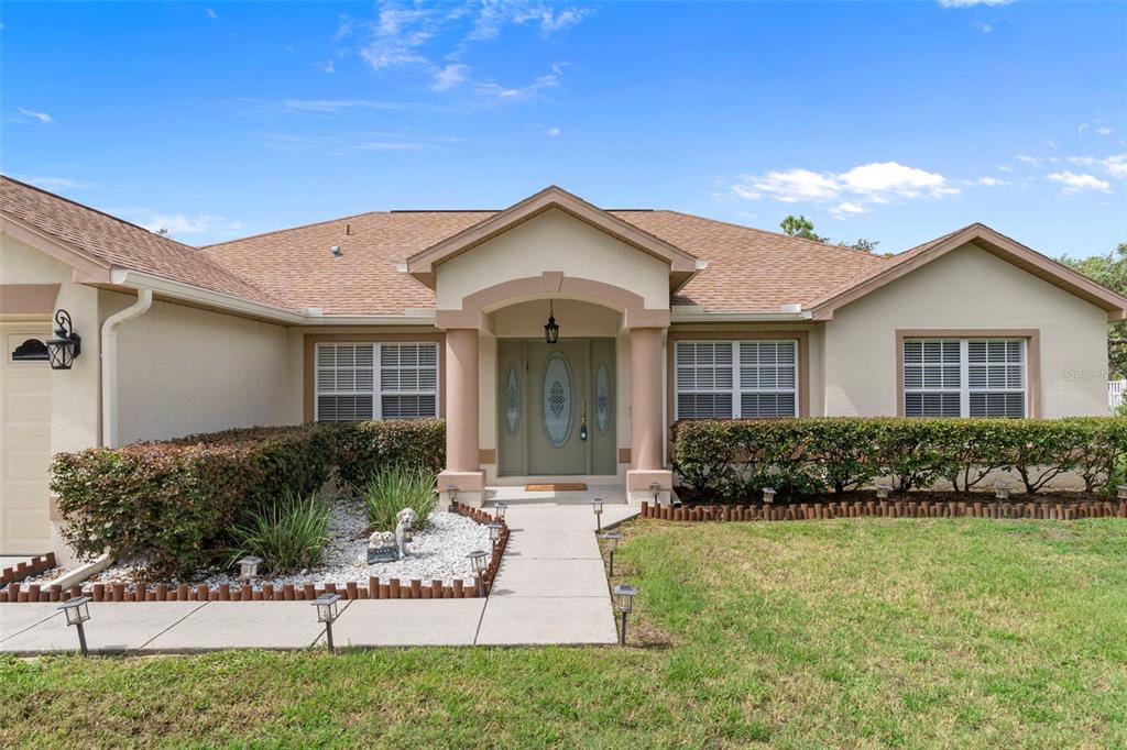 7 Bigleaf Court Homosassa, FL 34446 - Photo 7 of 71 a front view of a house with garden