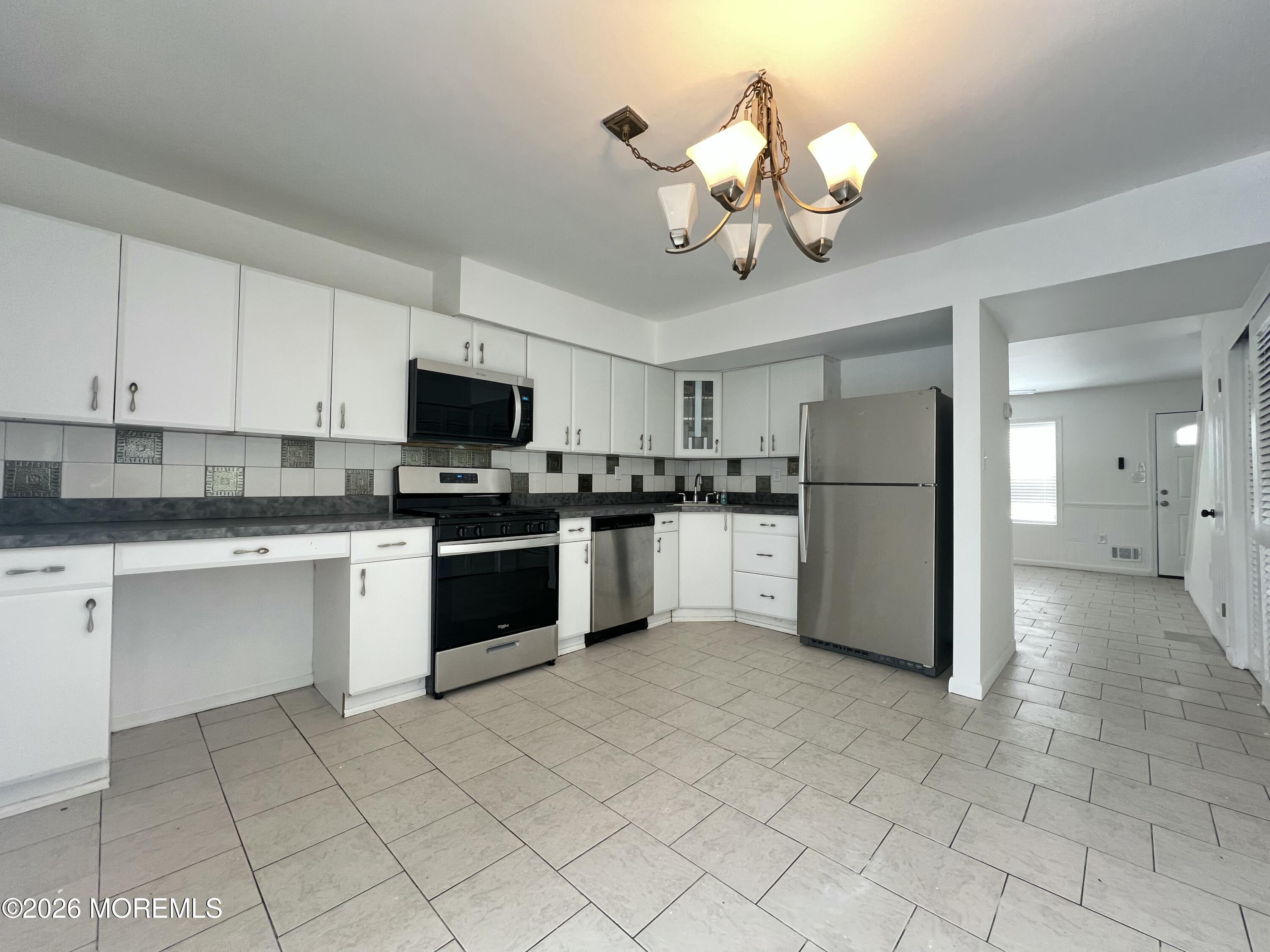 29 Sawmill Road Brick, NJ 08724 - Photo 2 of 21 a kitchen with a white cabinets and white appliances