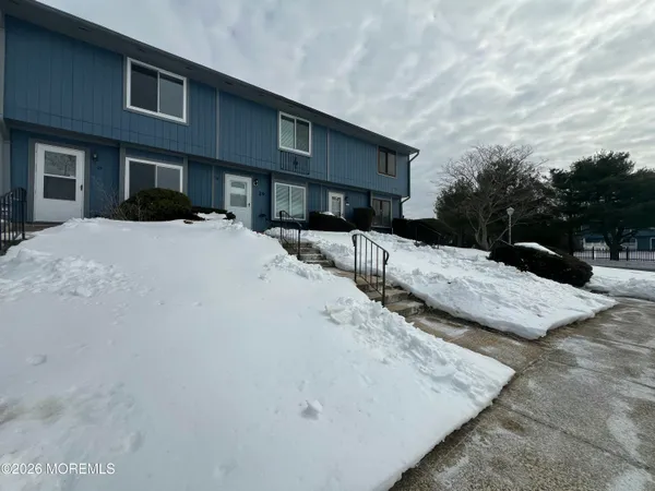 a view of a house with a snow in the yard